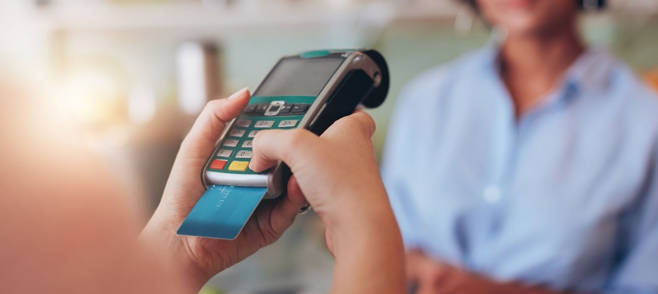 closeup of a debit card in a card reader payment terminal