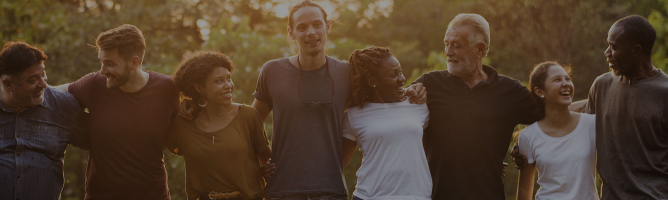 group of people linked arm in arm outdoors