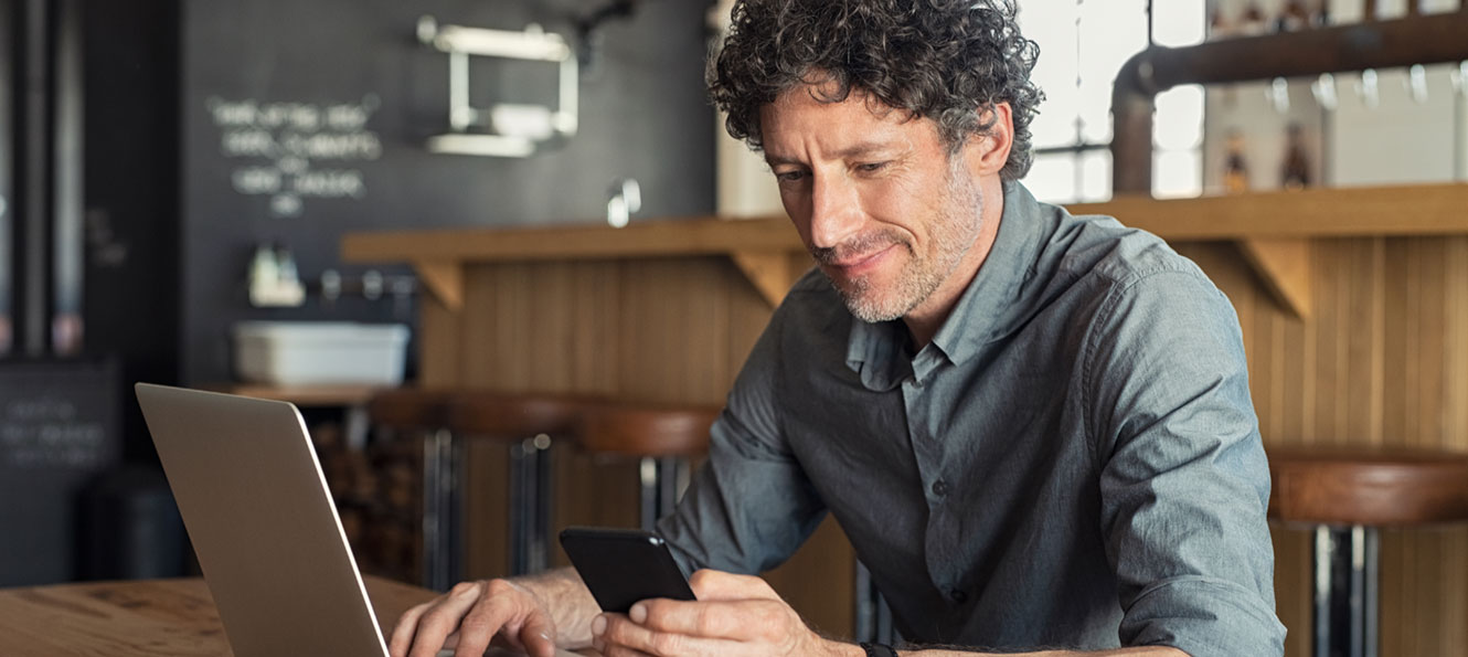 man paying bill on his computer looking at his cad