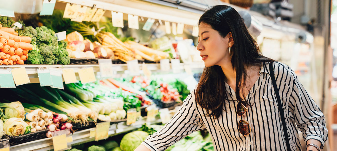 woman shopping in the produce department of a grocery story