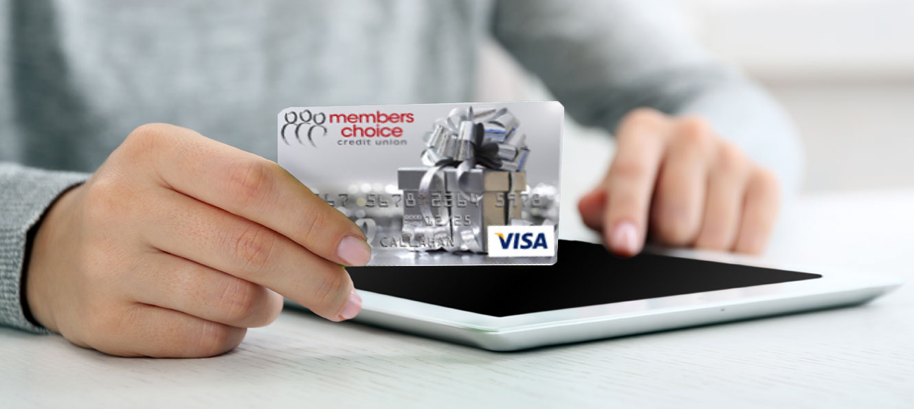 person using a gift card and their tablet device