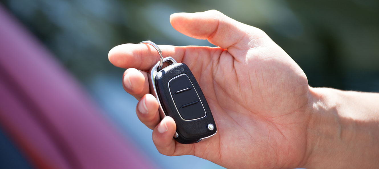 closeup of a hand holding a car key fob