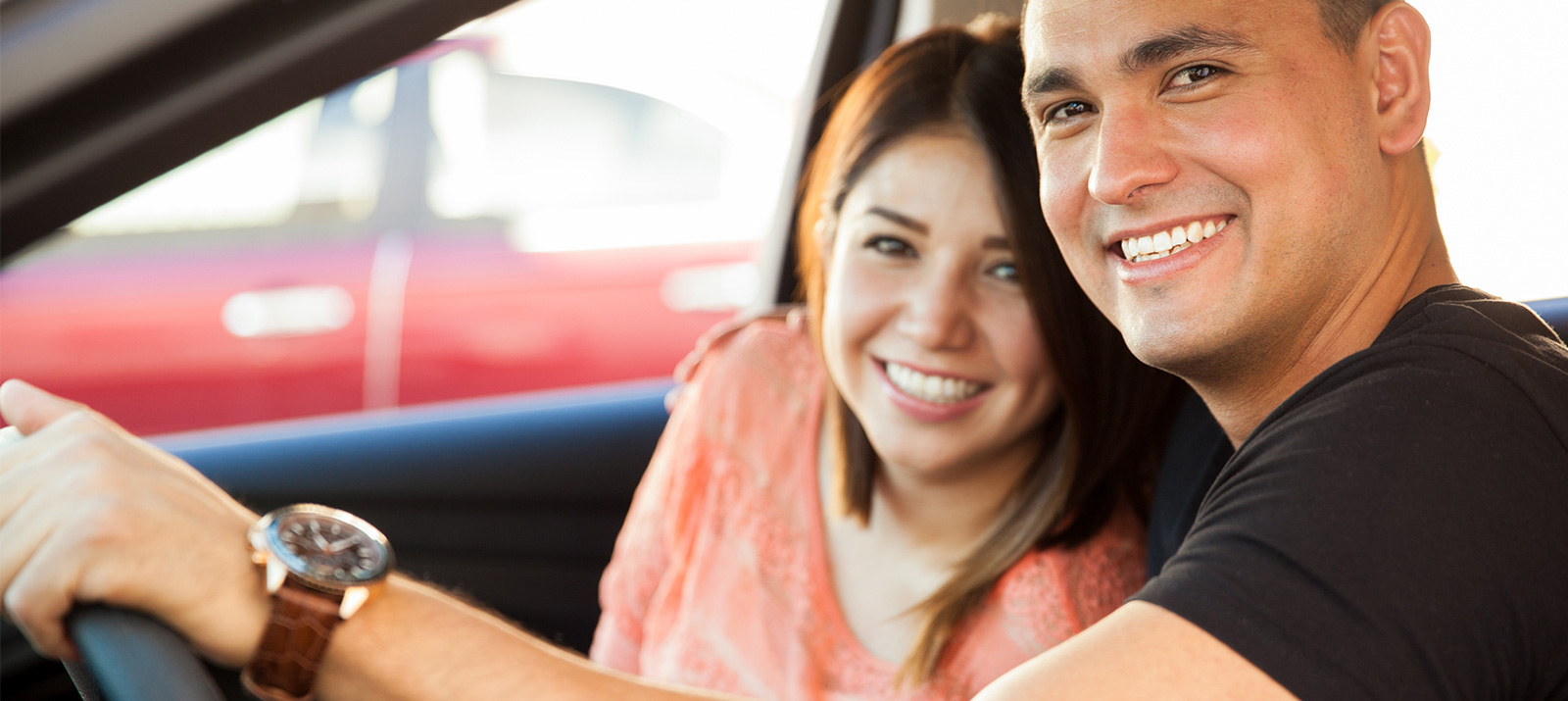Couple in car smiling at camera