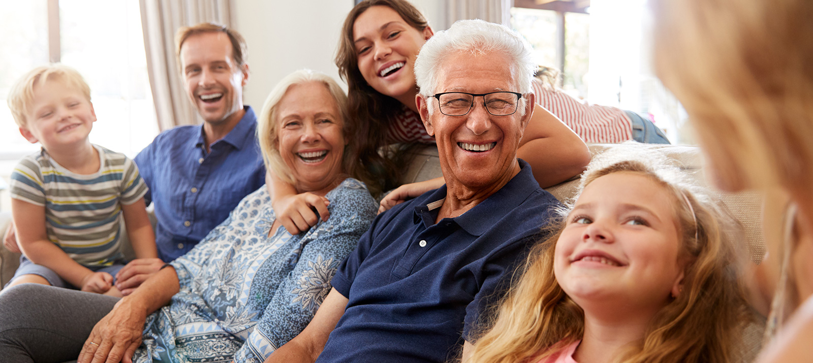 Generations of a family sitting together on a sofa