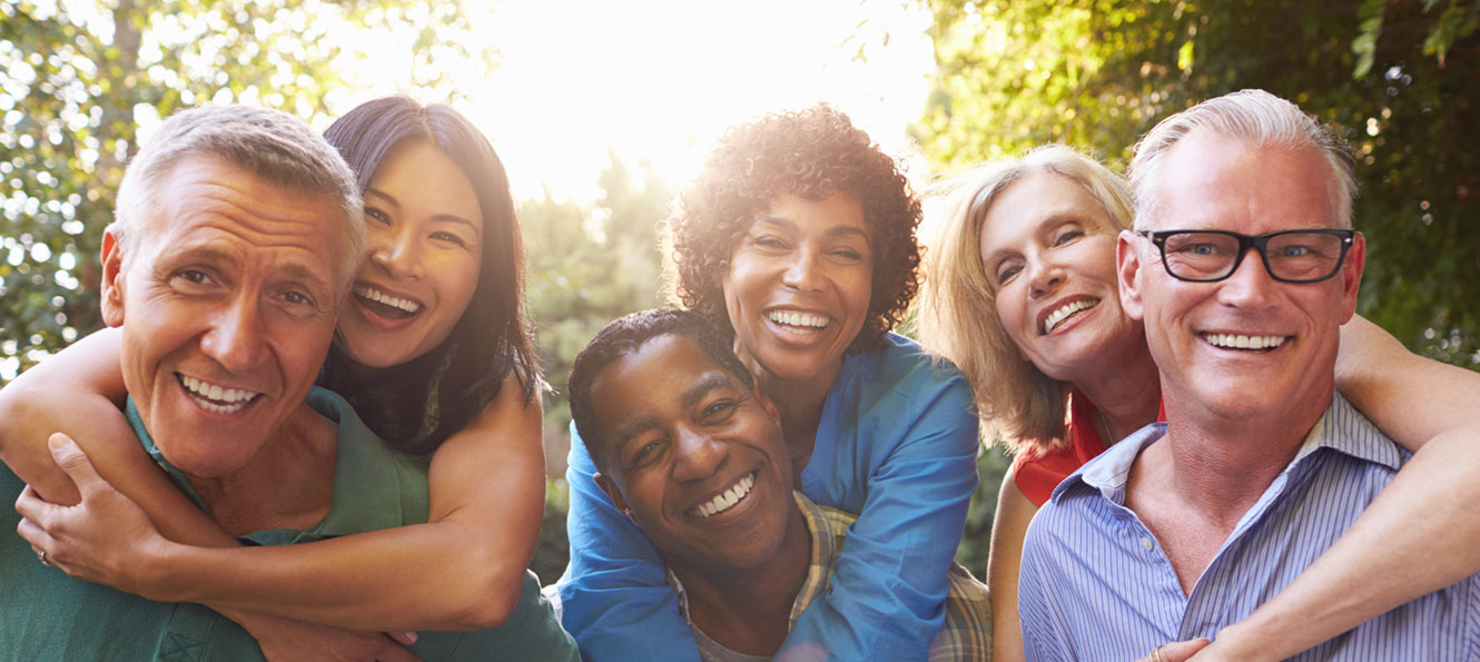 group of three couples hugging their spouse while smiling at the camera