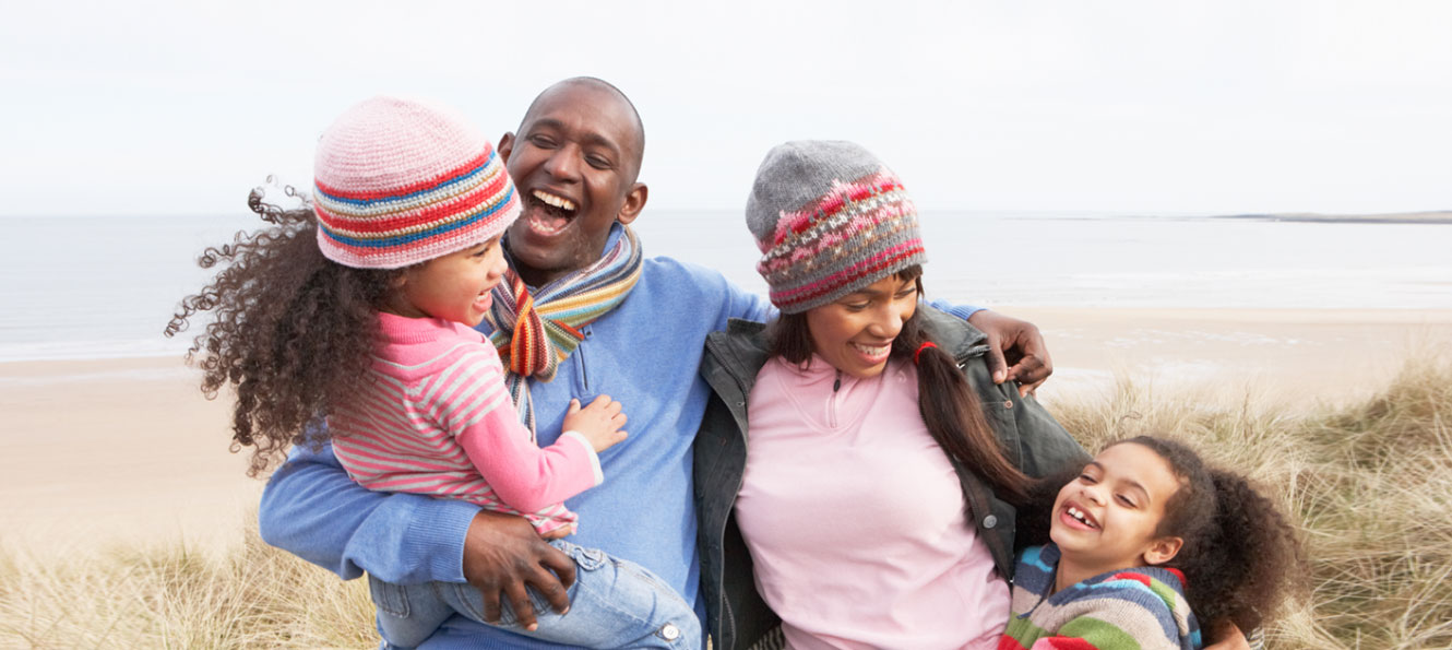 family of four enjoying a winter beach vacation