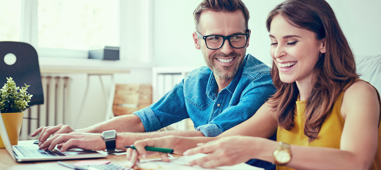 couple using a computer to pay bills together