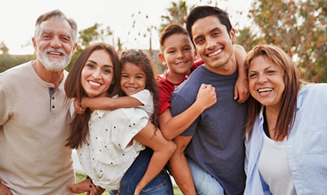 extended family portrait while gathered together and smiling outdoors