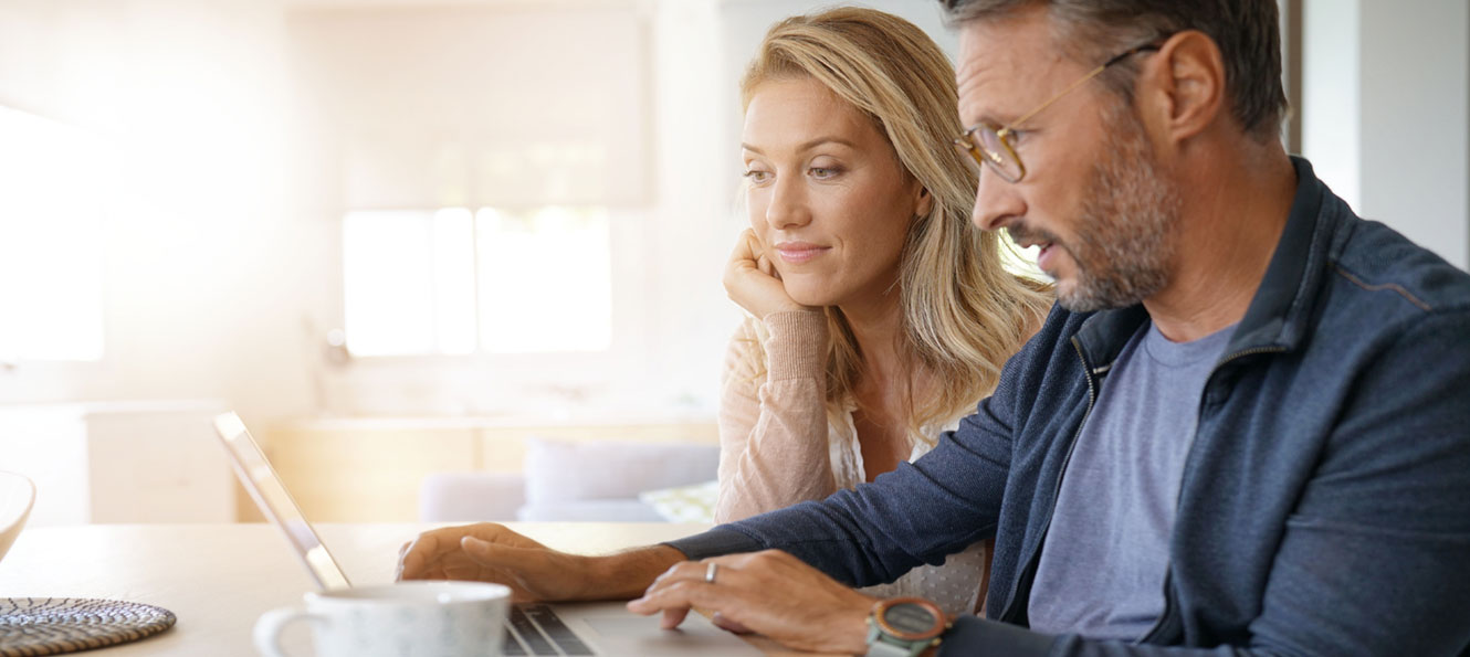 couple banking online with a computer at home