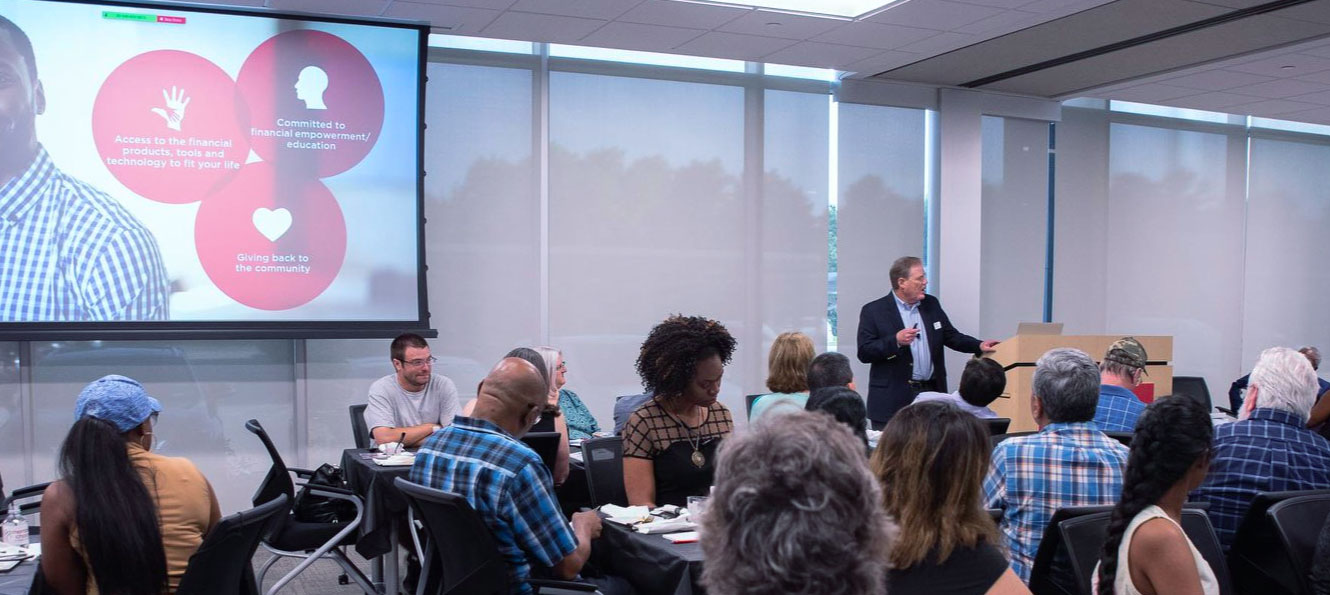 CEO giving a presentation to a crowded room at the annual meeting of members